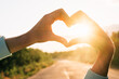 © Iurii - Hand shape heart against beautiful sunset