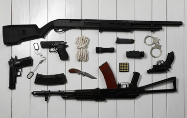 Wall Mural - Flat lay composition with different guns on white wooden background