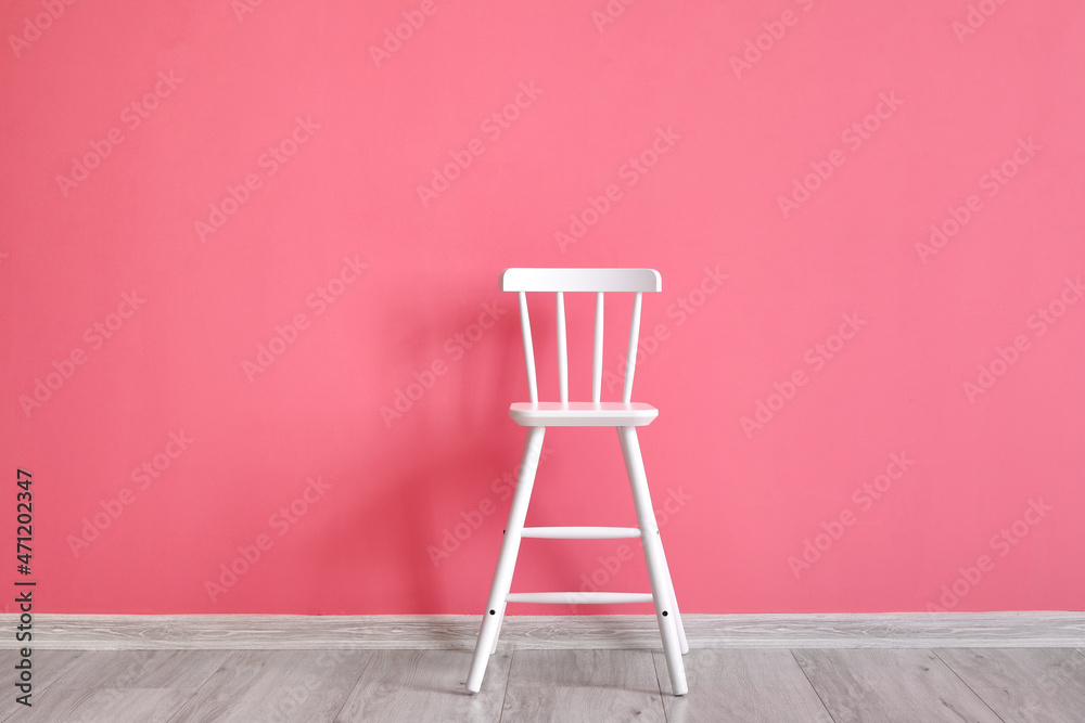 Modern chair near pink wall