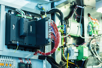 Poster - Electrical equipment. Shield with lot of power and mains wires. Fiber optic wires are connected to switch. Distribution of lacquer net in enterprise. Industrial type internet switch. Network hardware