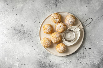 Wall Mural - Homemade coconut cookies in a white plate on a light gray culinary background	