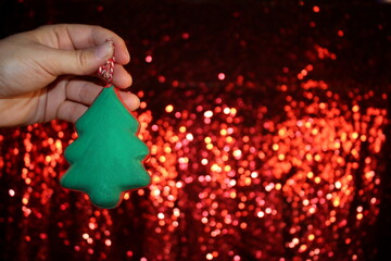 Wall Mural - beautiful green Christmas tree is lying on your hand on a shiny background