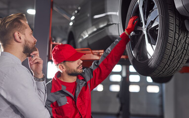 Car mechanic and client in workshop