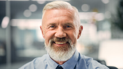 Leinwandbilder - Portrait of a Confident Happy Senior Male Wearing Blue Shirt, Looking at Camera, Genuinely and Charmingly Smiling. Successful Experienced Older Man Working in Diverse Company Office.