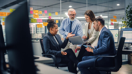 Aufkleber - In Modern Office: Diverse Team of Managers Use Laptop and Tablet Computers at a Company Meeting Discussing Business Projects. Young, Motivated and Experienced Employees Brainstorm in Conference Room.