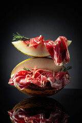 Wall Mural - Prosciutto with melon and rosemary.