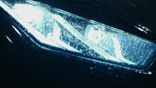 Close-up of headlights burning at night. Burning car headlight.