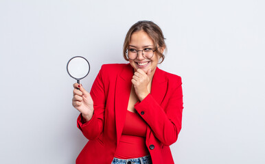 Wall Mural - hispanic pretty woman smiling with a happy, confident expression with hand on chin. magnifying glass concept