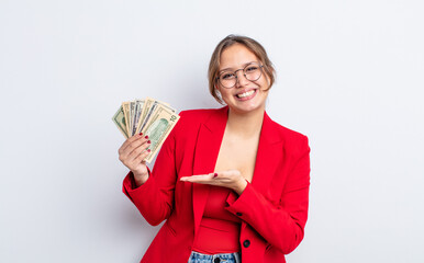 Wall Mural - hispanic pretty woman smiling cheerfully, feeling happy and showing a concept. business and banknotes concept