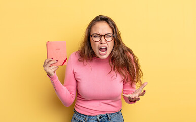 Wall Mural - hispanic pretty woman looking angry, annoyed and frustrated. agenda concept