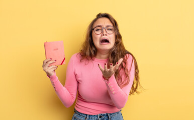 Wall Mural - hispanic pretty woman looking desperate, frustrated and stressed. agenda concept