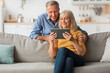 © Prostock-studio - Happy Senior Couple Using Digital Tablet Browsing Internet At Home