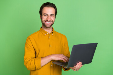 Aufkleber - Photo of nice young ceo brunet guy type laptop wear eyewear smart casual shirt isolated on green color background