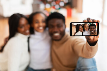 Wall Mural - Happy African American family taking selfie on Xmas