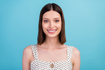 Wall Mural - Photo of cheerful positive lovely cute lady shiny white smile wear dotted overall isolated blue color background