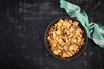 Wall Mural - Pasta Calamarata with chicken meat, mushrooms and soy sauce. Italian cuisine. Top view, overhead