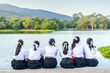 © jaboo_foto - group of thai student girls friend in uniform sitting outdoor lakeside