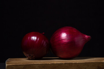 Canvas Print - Red onion isolated on a black background. Healthy vegetable. Onion variety