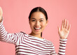 © Prostock-studio - Hello. Cheerful Young Asian Female Taking Selfie And Waving Hand At Camera