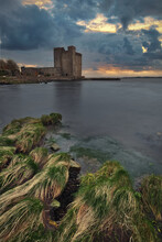 Dramatic Cloudy Sunset Scenery Of Oranmore Castle On The Rocky Coast Of Wild Atlantic Way In County Galway, Ireland 