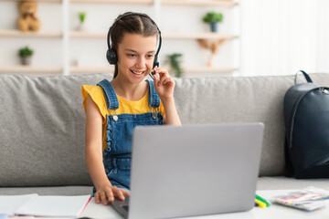 Poster - Girl sitting at desk, wearing headphones playing game