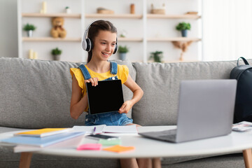 Poster - Girl sitting at desk, using pc, showing tablet