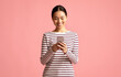 © Prostock-studio - Mobile Communication. Young Happy Asian Woman Using Smartphone For Messaging With Friends