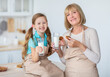 © Prostock-studio - Grandma And Cute Little Girl Eating Cookies Drinking Milk