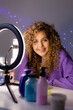 © КРИСТИНА Игумнова - beauty blogger girl is broadcasting live from her smartphone and doing a review of cosmetics and care products. young woman vlogger. ring lamp. High quality photo