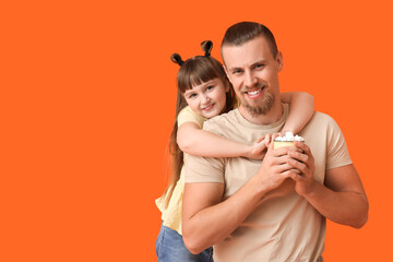 Wall Mural - Happy daughter and father with cup of hot cocoa on color background