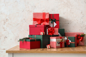 Canvas Print - Different gift boxes on wooden table near light wall