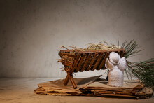 Manger With Angel And Old Book On Light Background. Concept Of Christmas Story