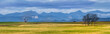 Canadian Rocky Mountain range beautiful rural Alberta prairies and grassland panoramic landscape. Oil pump jack in farmland