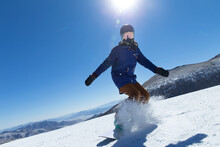 A Female Snowboarder Ski On The Snow Mountain
