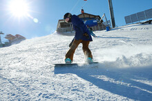 A Female Snowboarder On The Snow Slope