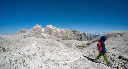 Wall Mural - A boy walking in the nature of dolomites