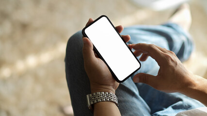 Close-up, top view of a man using a modern smartphone.