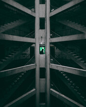 Low Angle View Of A Structural Architecture With Silhouette Of A Man In Green Light