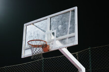 Low Angle View Of Basketball Hoop Against Black Background