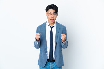 Wall Mural - Young Chinese business man isolated on white background celebrating a victory in winner position