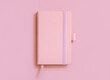 Pink hardcover notebook on light pink top view. Textbook cover mockup