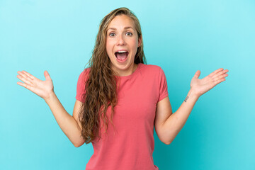 Young caucasian woman isolated on blue background with shocked facial expression