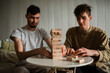 © Dima - Business people are planning a business strategy, a businessman is playing a wooden block tower, Plans and strategies in the concept of risky business