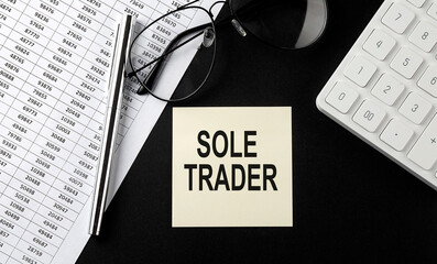 Poster - Concept SOLE TRADER message on sticker with glasses,chart and calculator on the black background