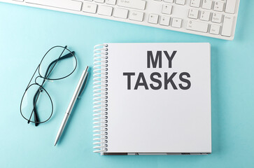 Poster - Keyboard, notebook,pen and glasses on the blue background with text MY TASKS