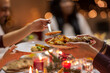 © Syda Productions - holidays, eating and celebration concept - close up of friends having christmas dinner at home and sharing food