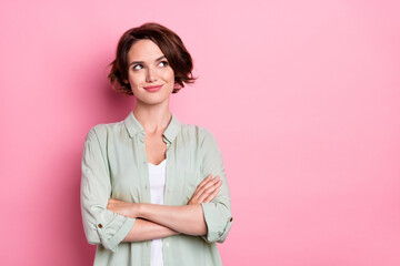 Sticker - Portrait of attractive curious brown-haired girl folded arms thinking copy space isolated over pastel pink color background