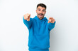 © luismolinero - Young caucasian man isolated on white background surprised and pointing front