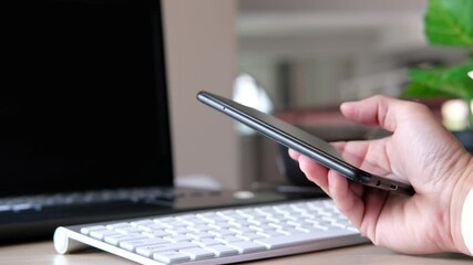 Wall Mural - Concept of a businessman using a smartphone on a desk and technology 