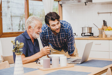 young man with healthy elder enjoy using computer online for watching and talking on internet video call meeting with grandchild during stay home